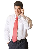 Young successful businessman on cellphone, isolated on white